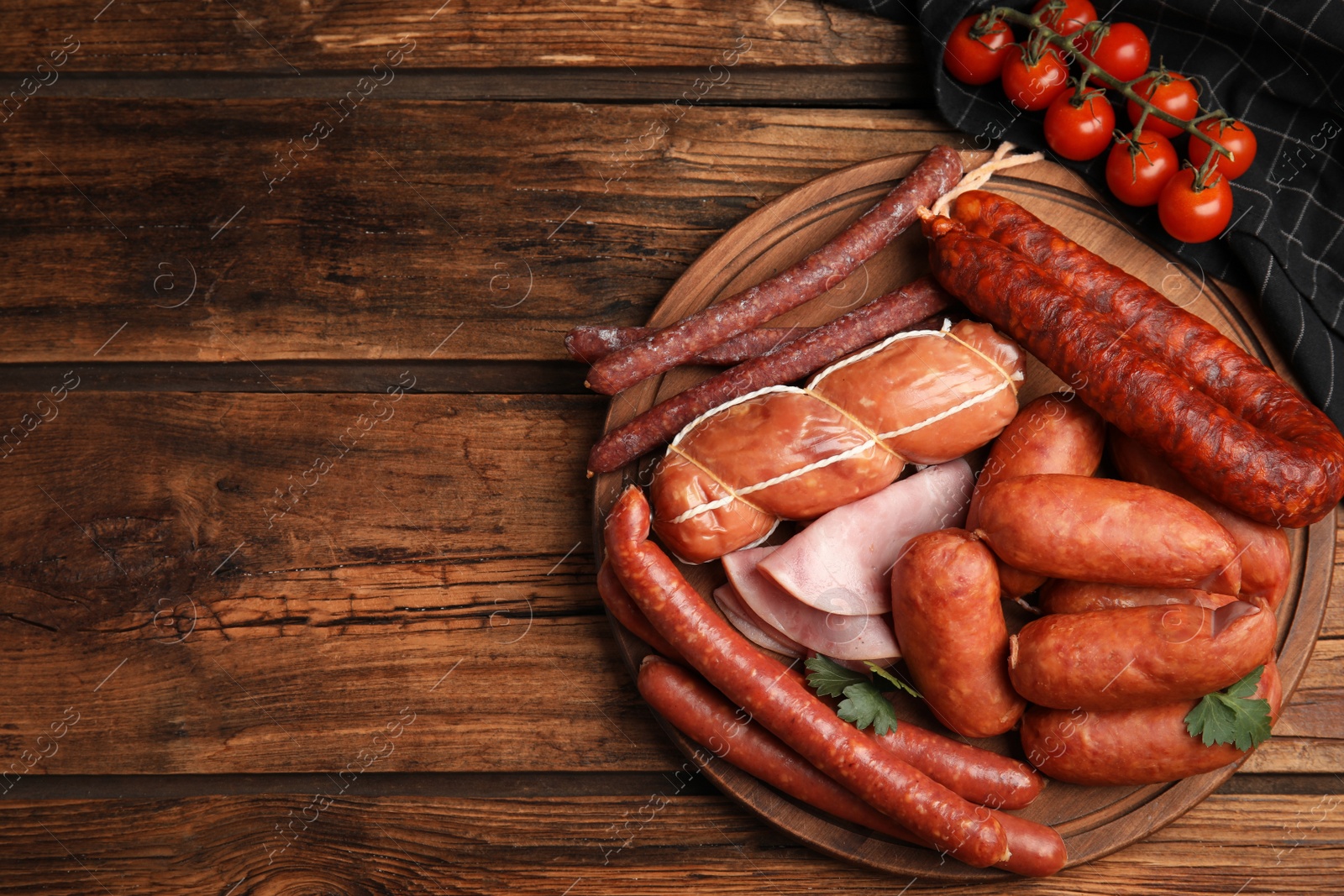 Photo of Different tasty sausages on wooden table, top view. Space for text