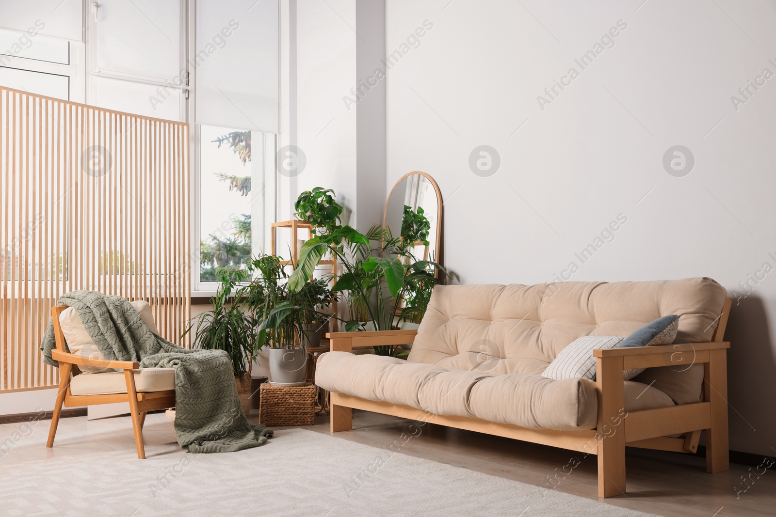 Photo of Stylish living room interior with comfortable sofa and beautiful houseplants