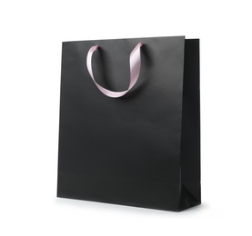 Photo of Paper shopping bag with ribbon handles on white background. Mockup for design