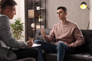 Photo of Professional psychotherapist working with patient in office