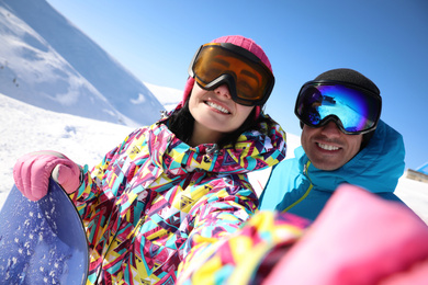 Photo of Couple taking selfie on hill. Winter vacation