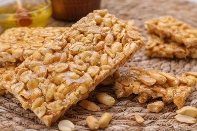 Photo of Delicious peanut bars (kozinaki) on wicker mat, closeup