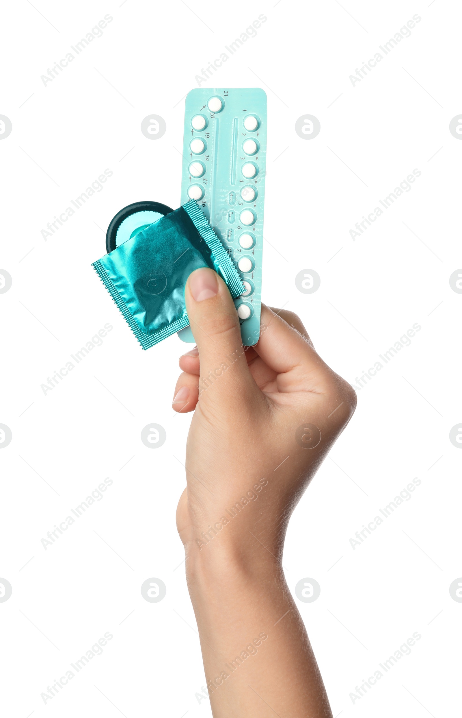 Photo of Young woman holding birth control pills and condom on white background, closeup. Safe sex concept