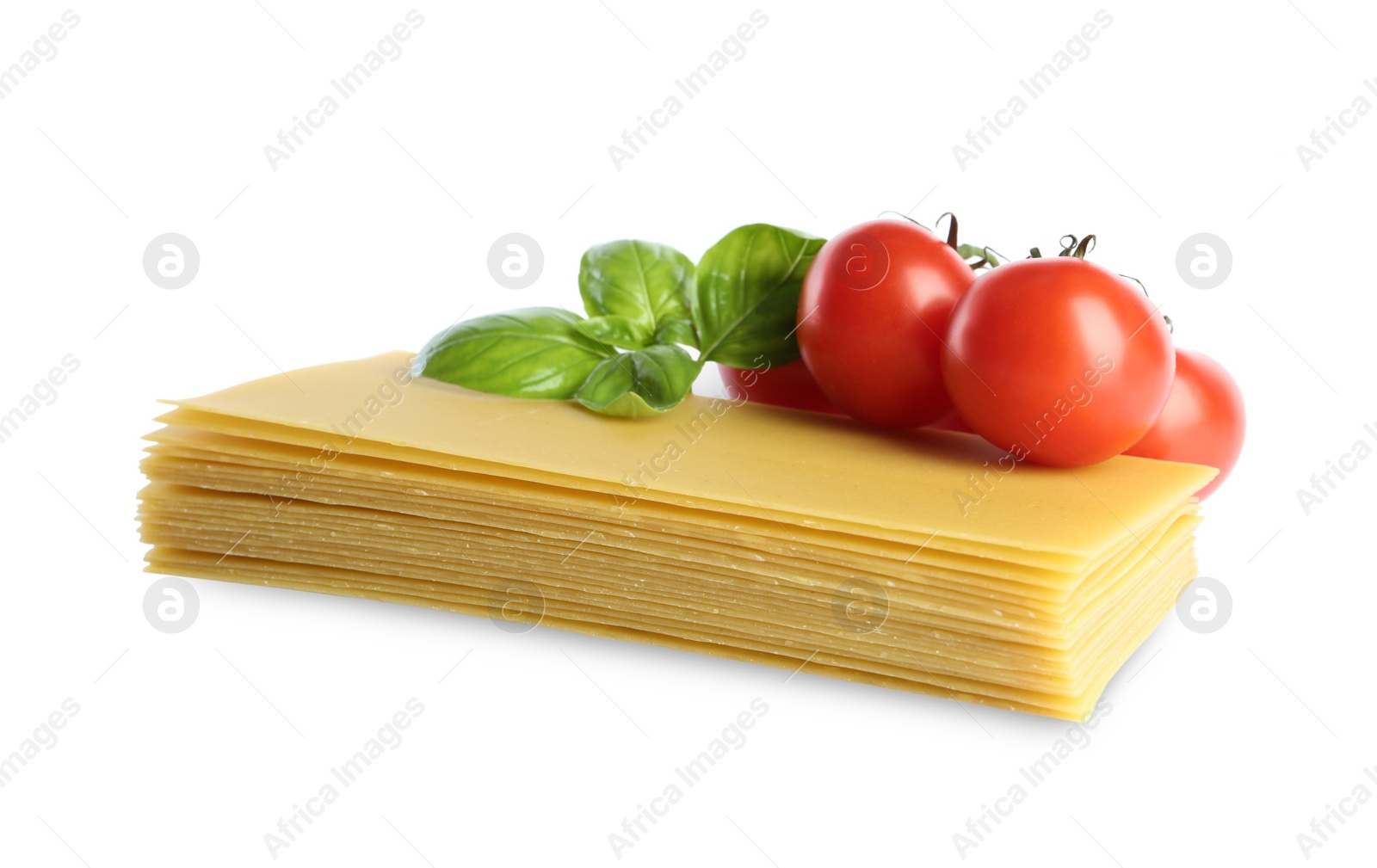 Photo of Uncooked lasagna sheets, tomatoes and basil on white background