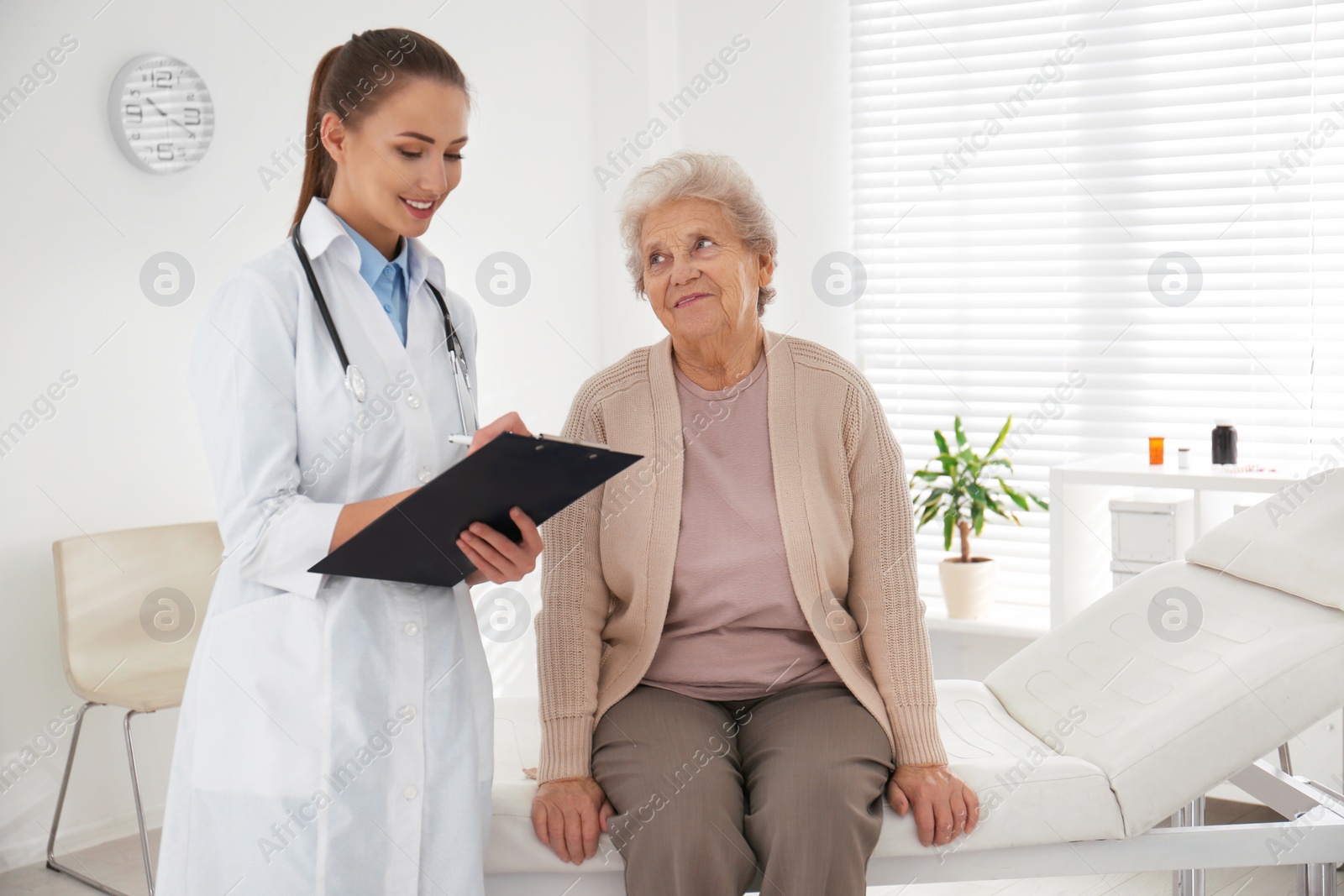 Photo of Doctor examining senior patient in modern office