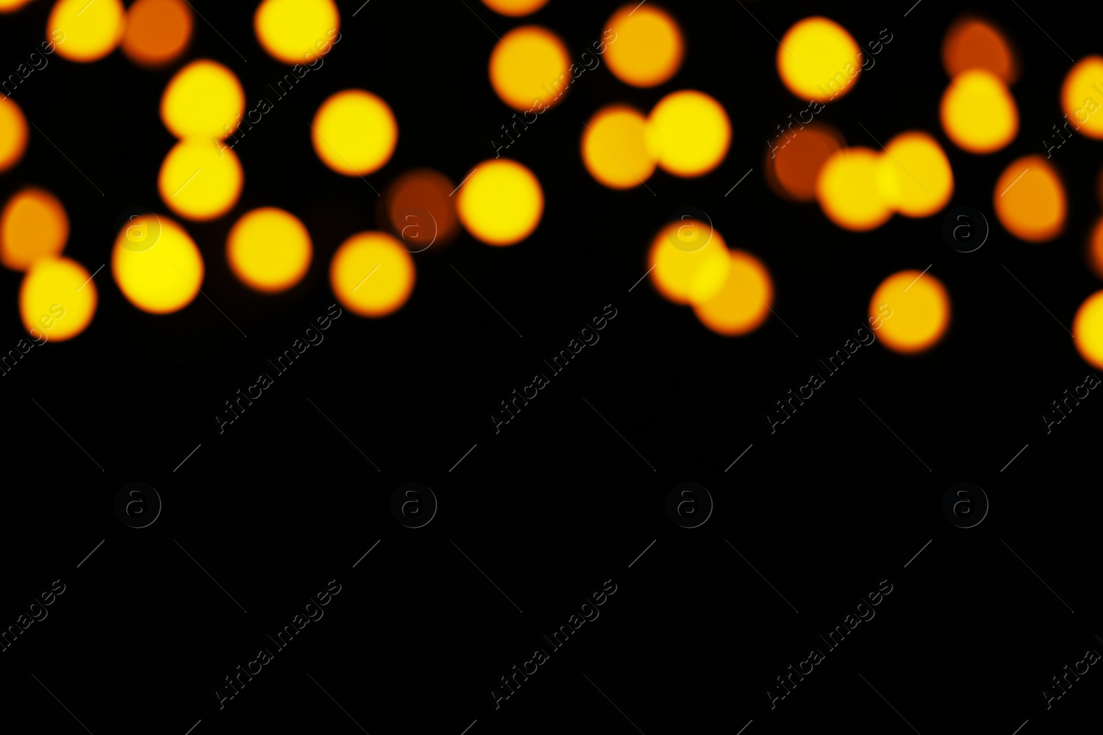 Photo of Blurred view of festive lights on black background, space for text. Bokeh effect