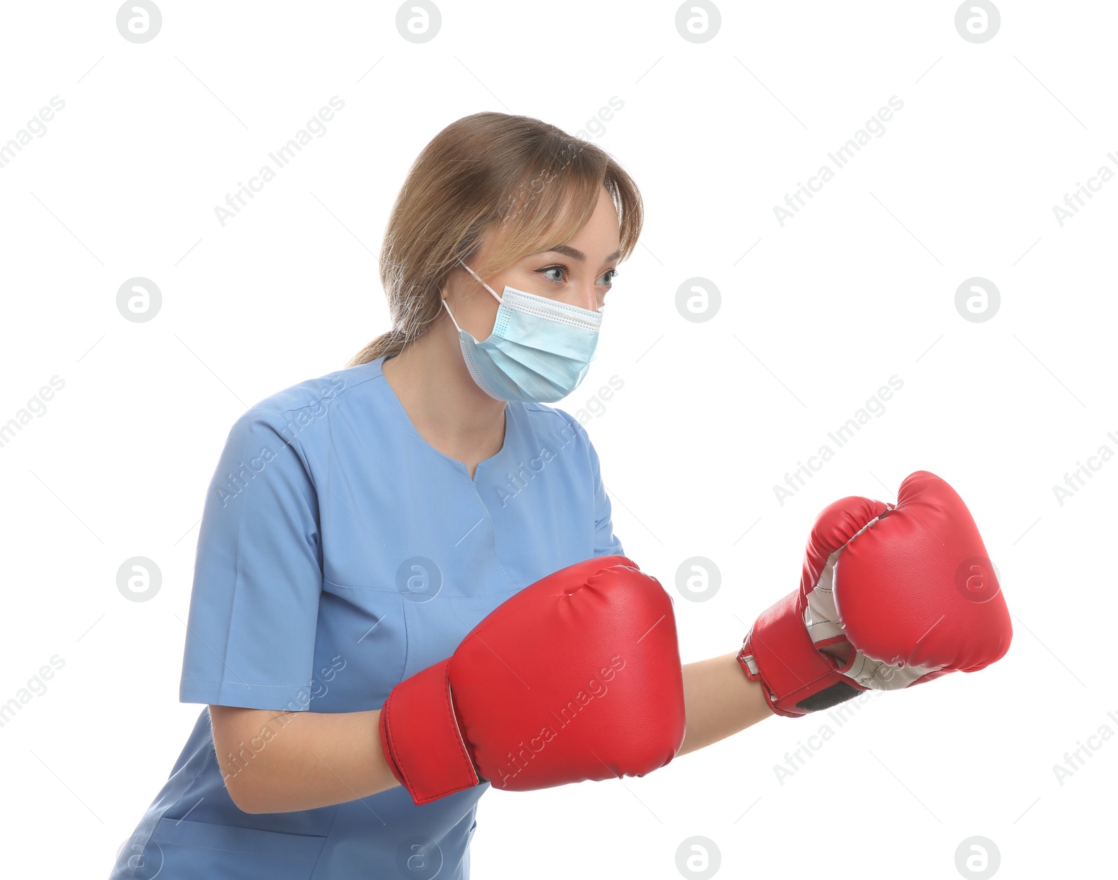 Photo of Doctor with protective mask and boxing gloves on white background. Strong immunity concept