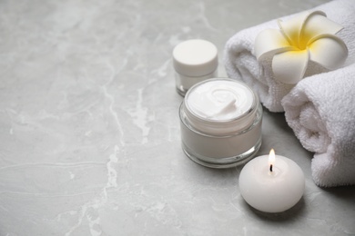 Photo of Composition with towels and skin care products on light grey marble background, space for text