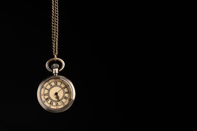 Photo of Beautiful vintage pocket watch with chain on black background, space for text. Hypnosis session