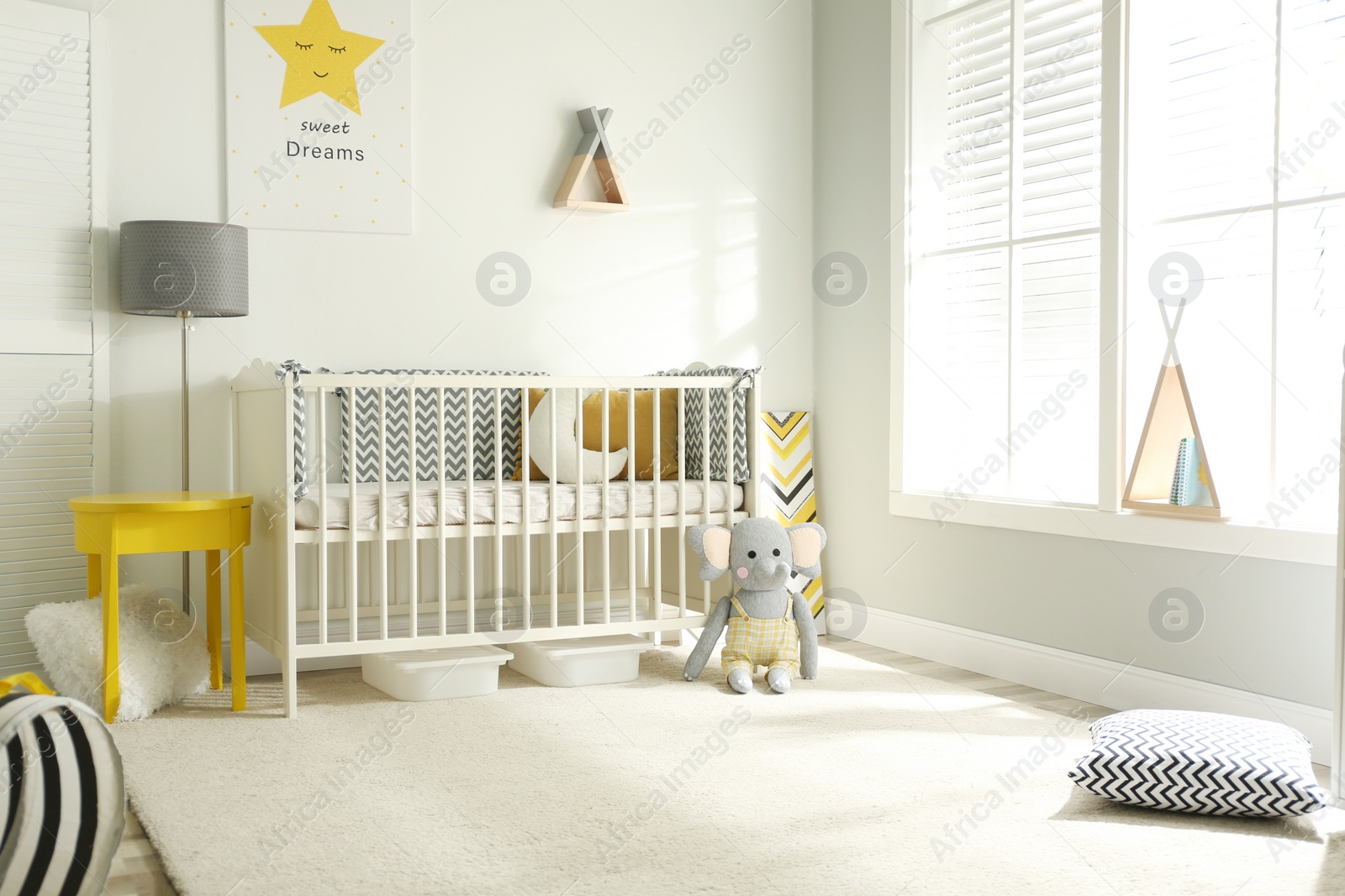 Photo of Cute baby room interior with crib and big window