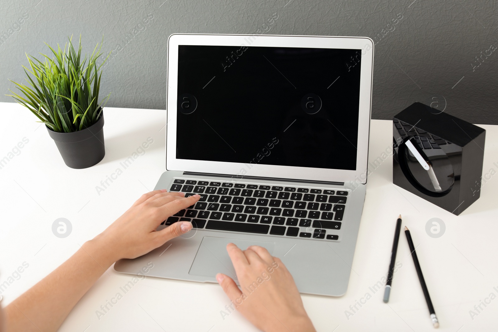 Photo of Woman working with laptop at home. Mock up with space for text