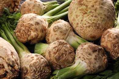 Photo of Fresh raw celery roots as background, closeup