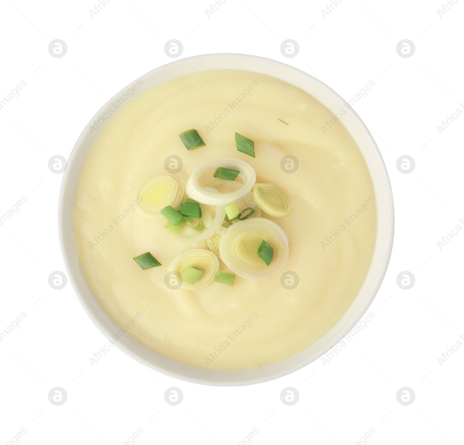 Photo of Bowl of tasty cream soup with cut leek isolated on white, top view