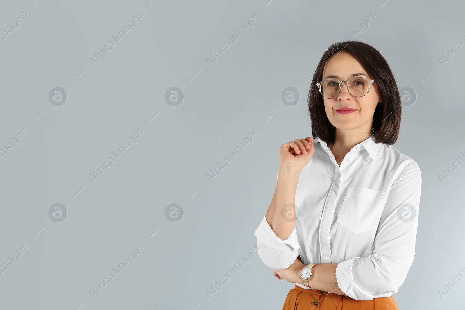 Photo of Portrait of mature businesswoman on light grey background. Space for text