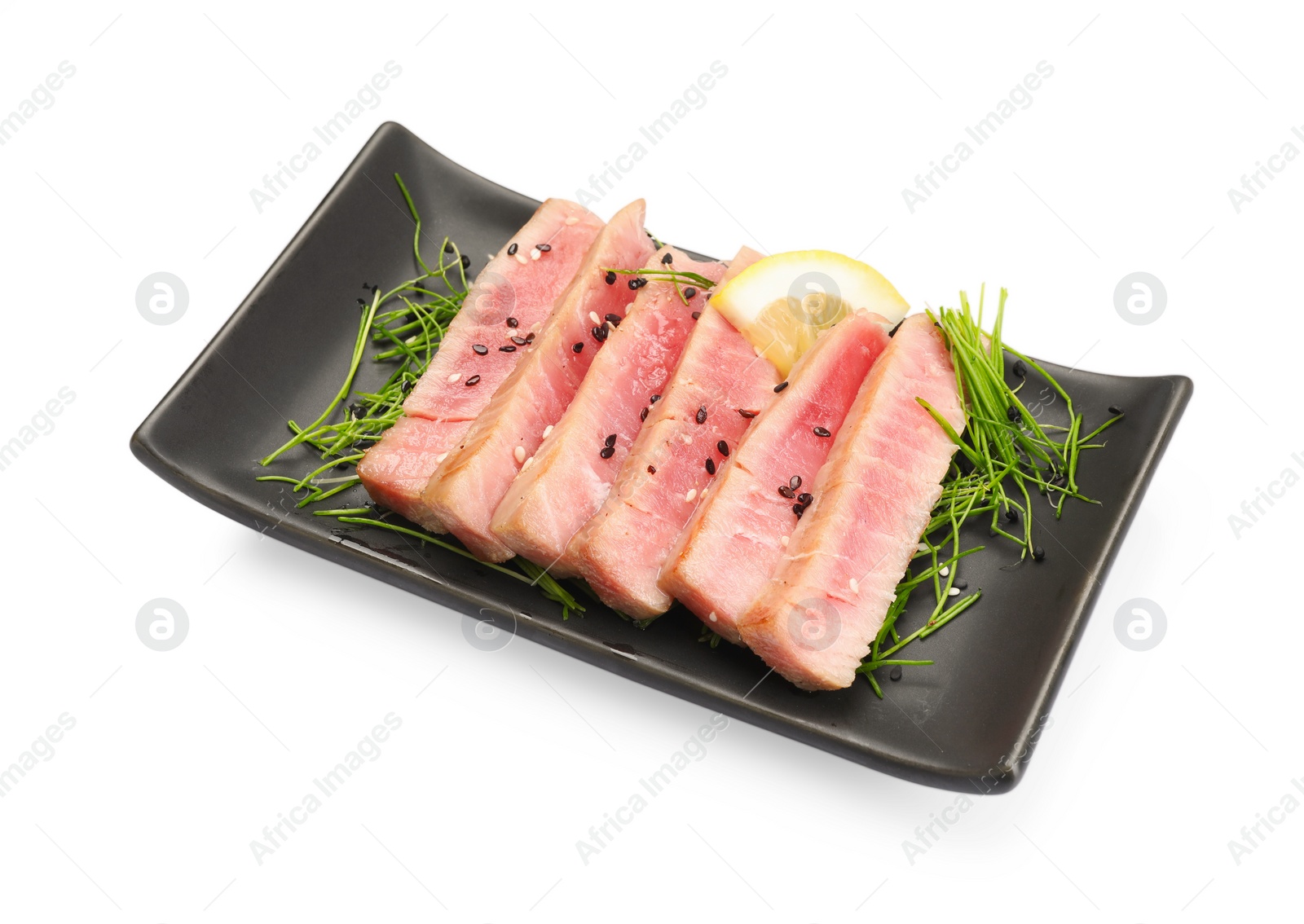Photo of Pieces of delicious tuna steak with microgreens and lemon isolated on white