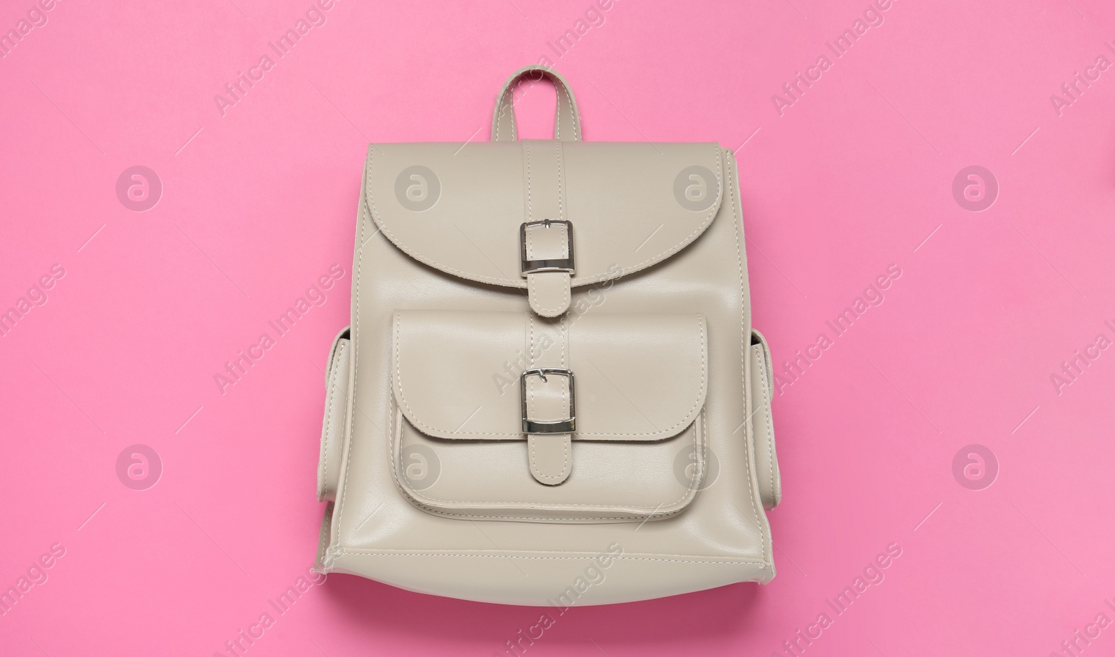 Photo of Stylish urban backpack on pink background, top view