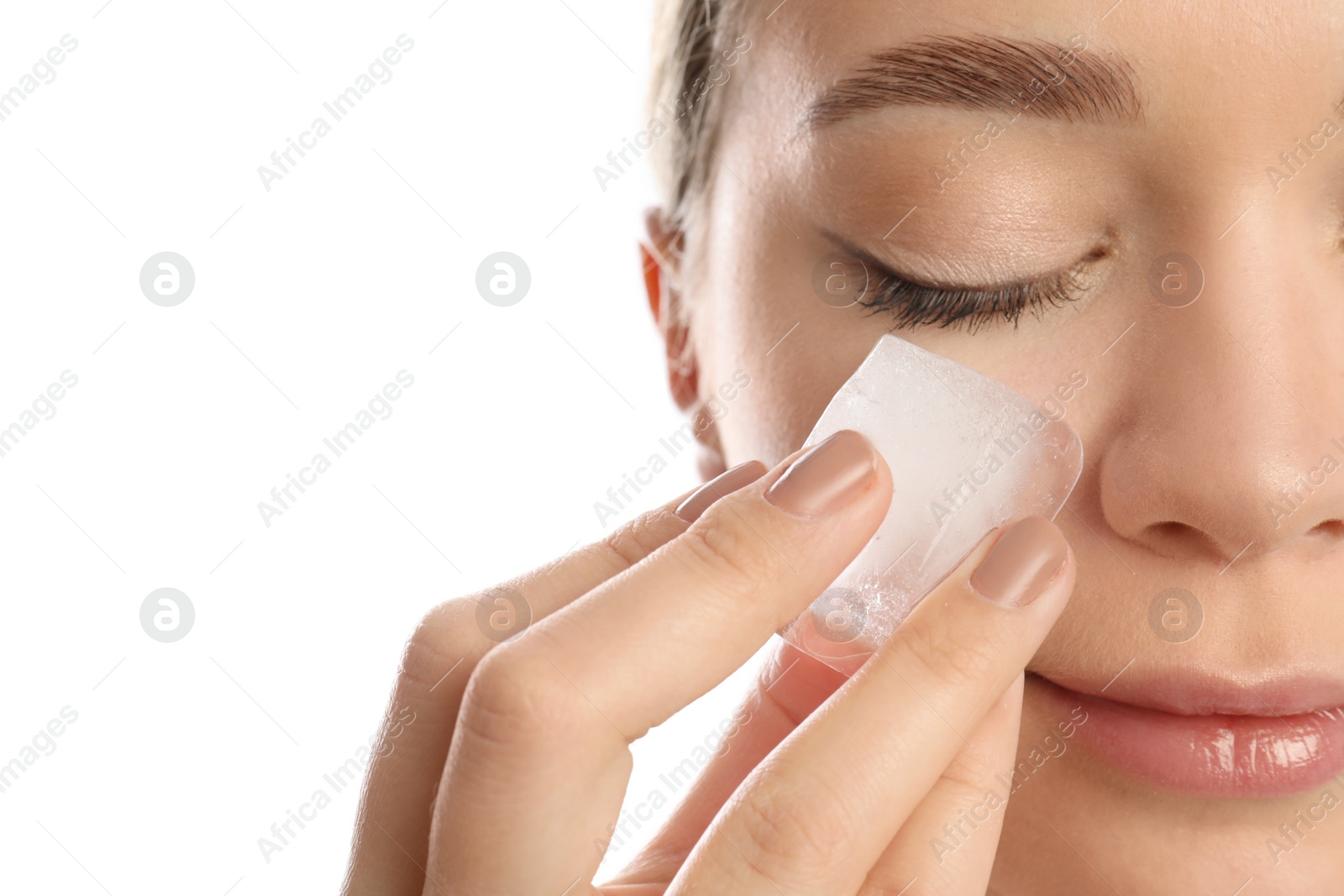 Photo of Young woman with ice cube on white background, closeup. Skin care