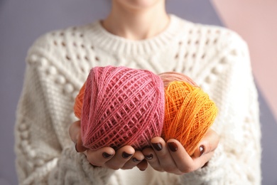 Photo of Woman holding clews of knitting threads, closeup