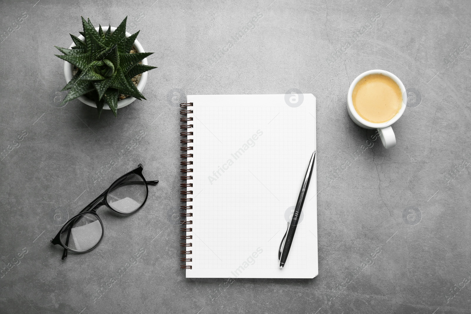 Photo of Flat lay composition with notebook on grey table