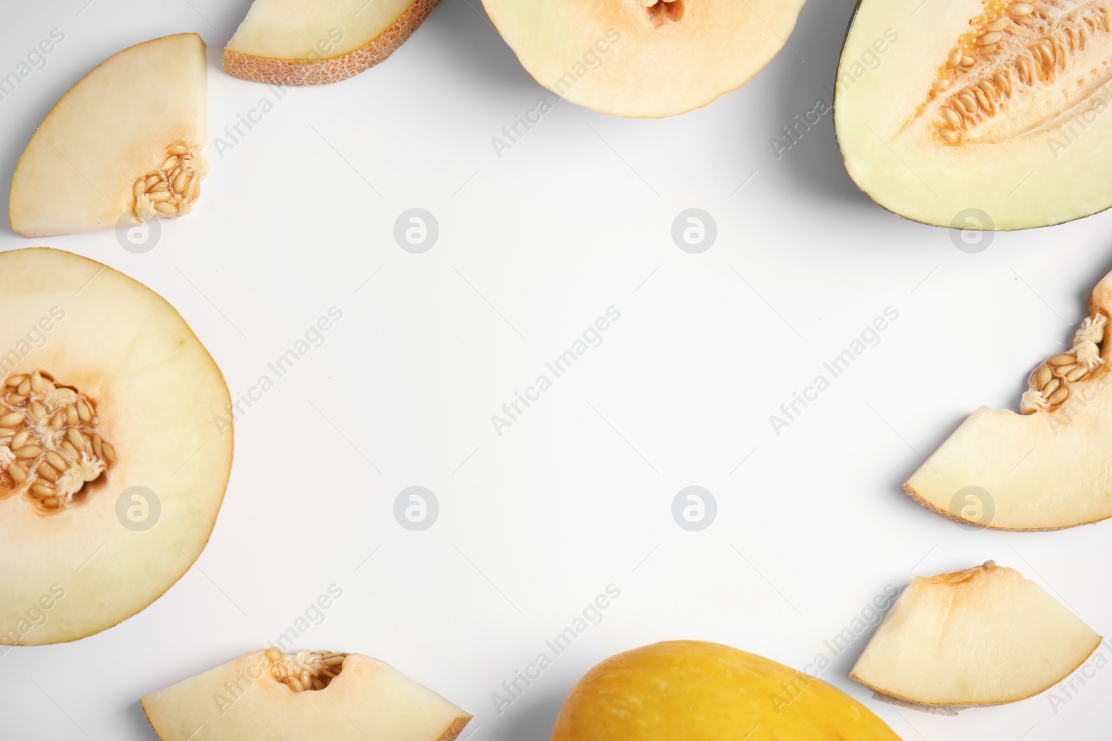 Photo of Frame made of cut melons with space for text on white background, top view