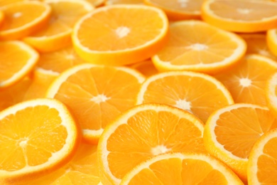 Photo of Many sliced fresh ripe oranges as background, closeup