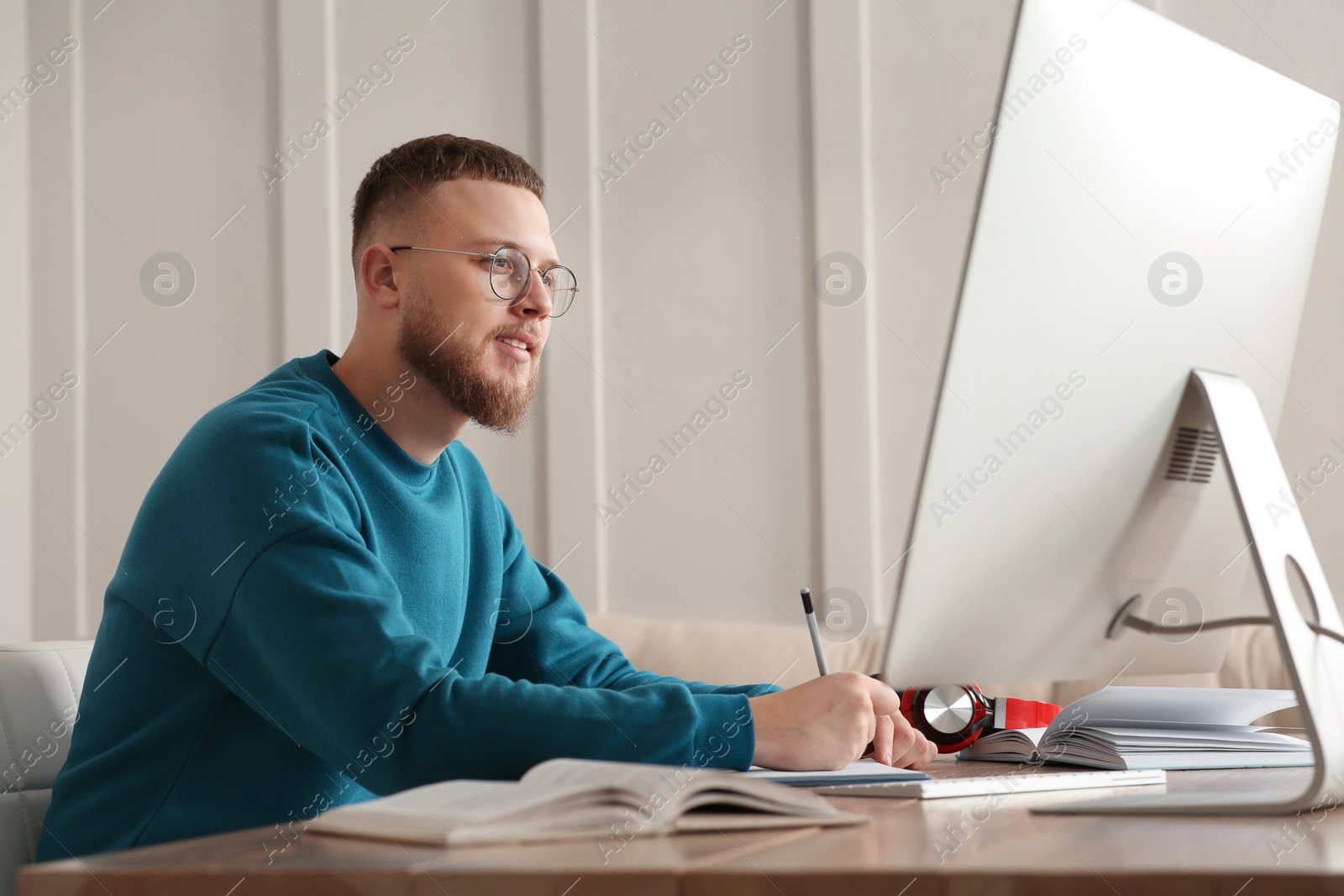 Photo of Online test. Man studying with computer at home