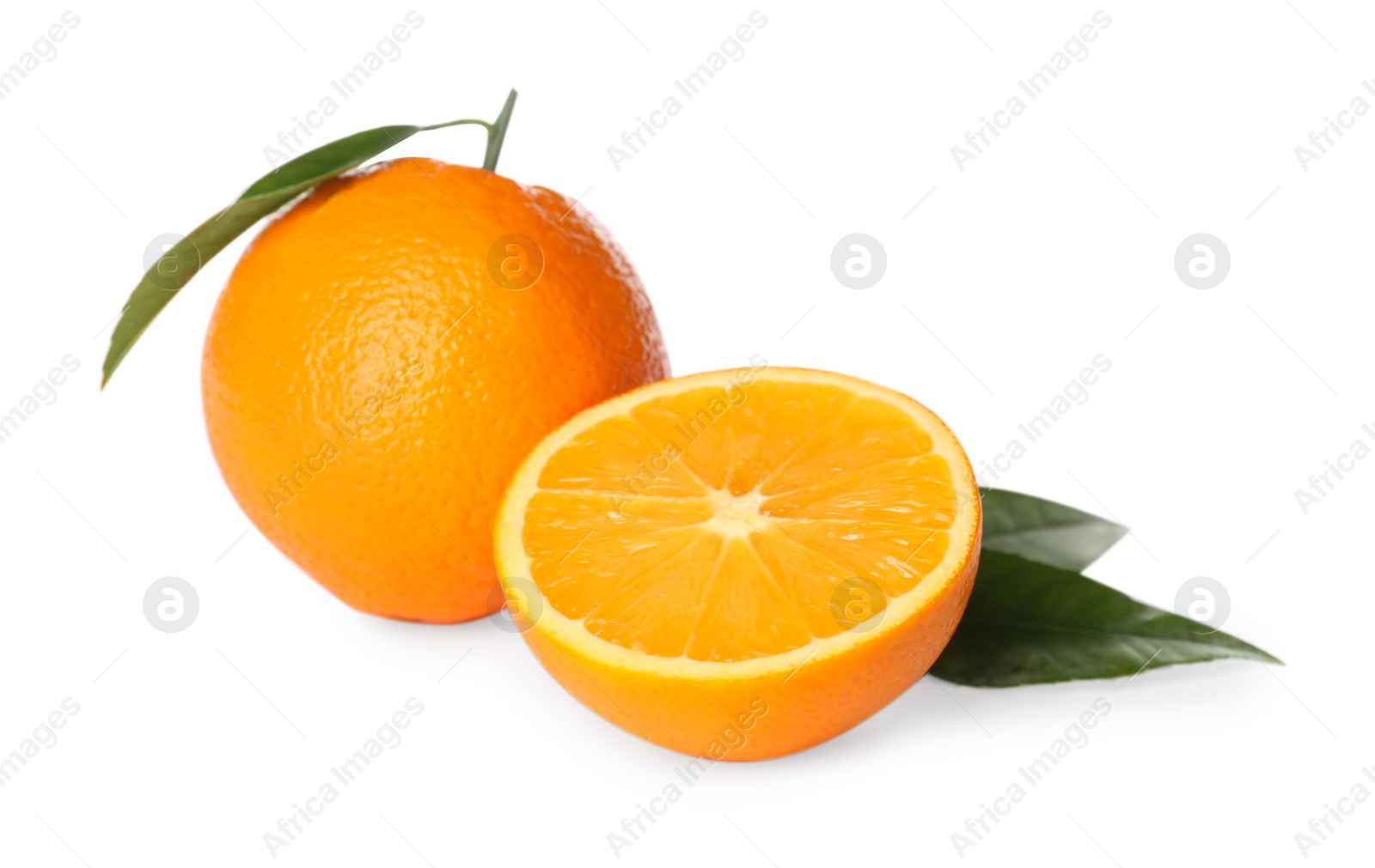 Photo of Cut and whole fresh ripe oranges with green leaves on white background