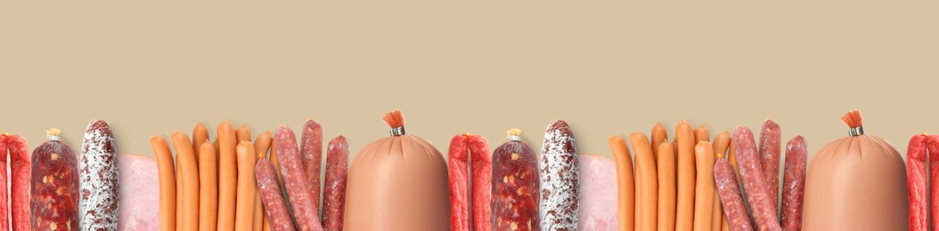 Image of Many different tasty sausages on beige background, flat lay. Banner design