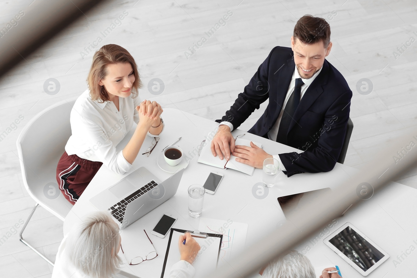 Photo of Group of people discussing ideas at table in office. Consulting service concept