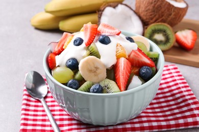 Delicious fruit salad with yogurt on table