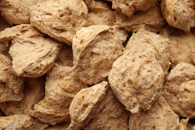 Dehydrated soy meat chunks as background, top view