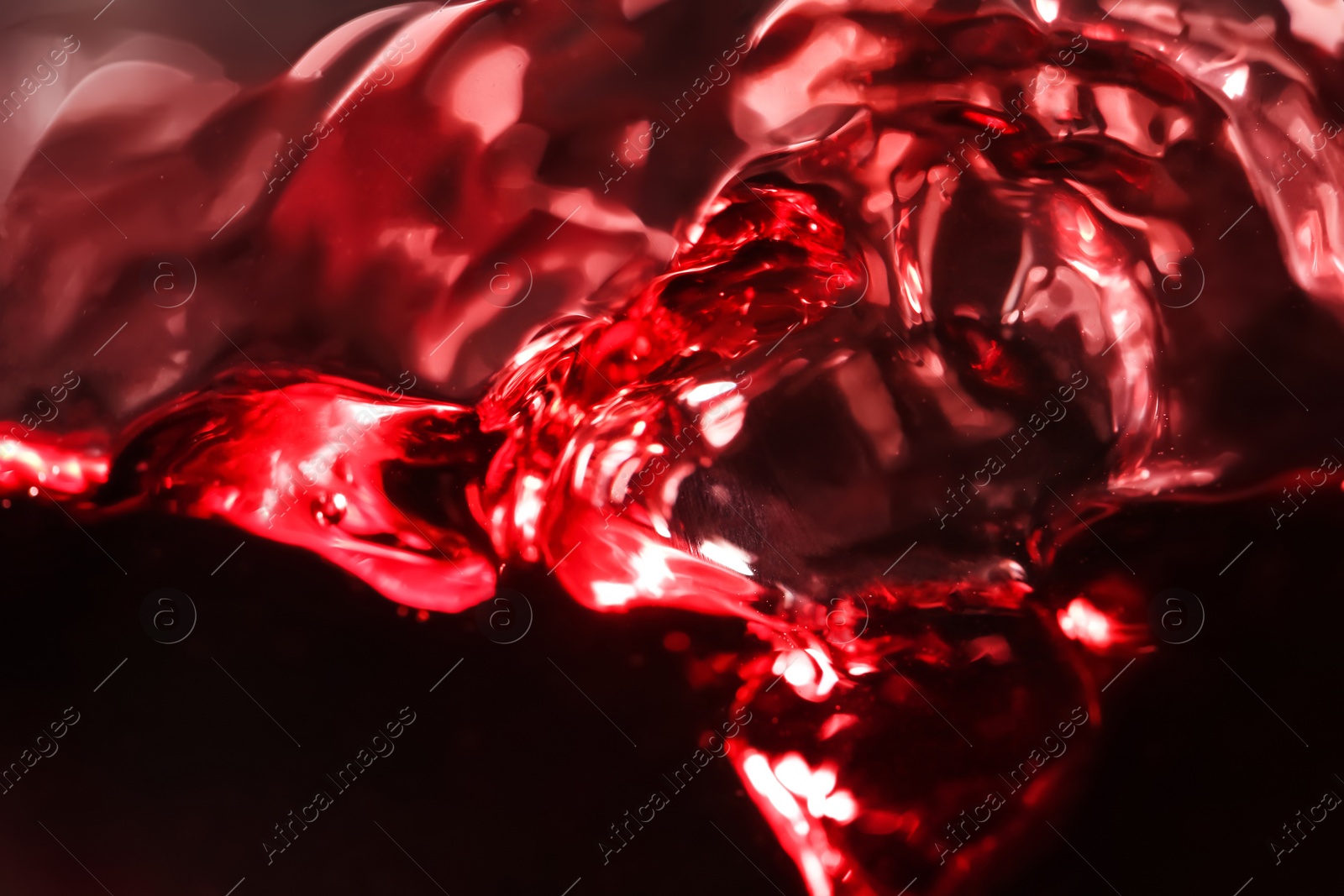 Photo of Delicious red wine in glass as background, closeup