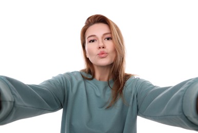 Beautiful woman taking selfie on white background