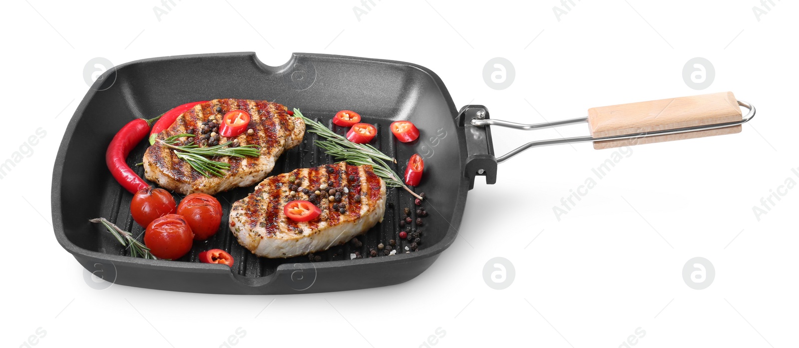 Photo of Grill pan with delicious pork steaks, spices and vegetables isolated on white