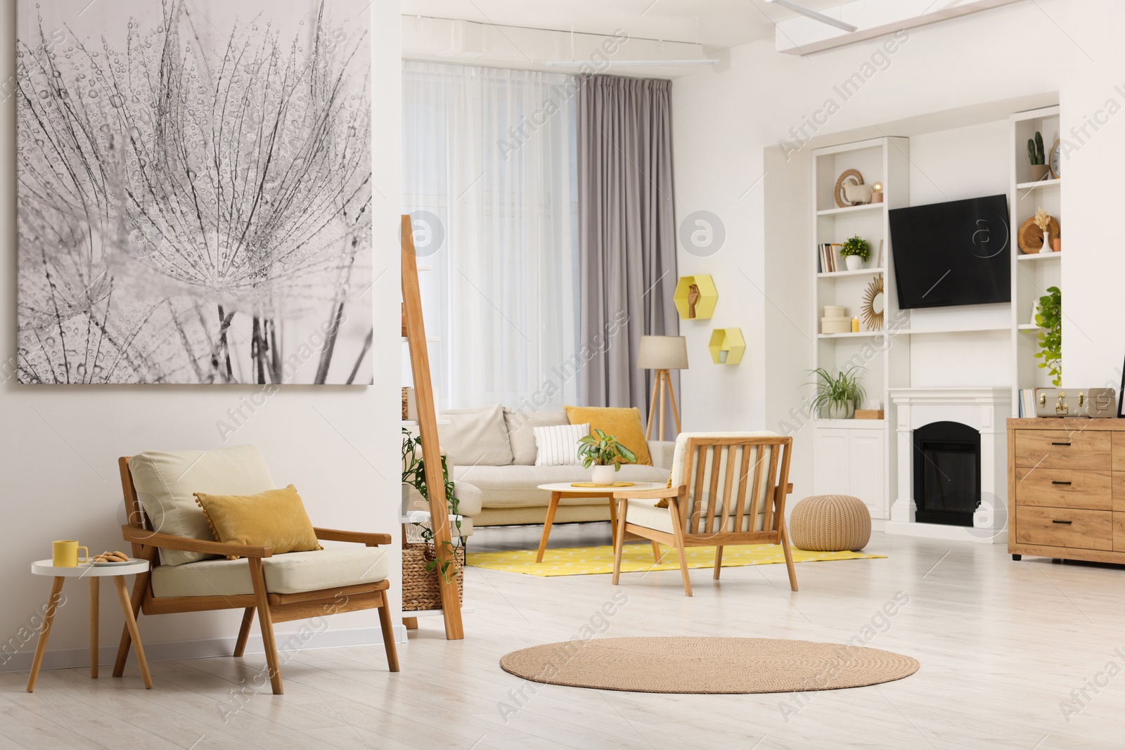 Photo of Spring atmosphere. Stylish room interior with cozy furniture in yellow and white colors