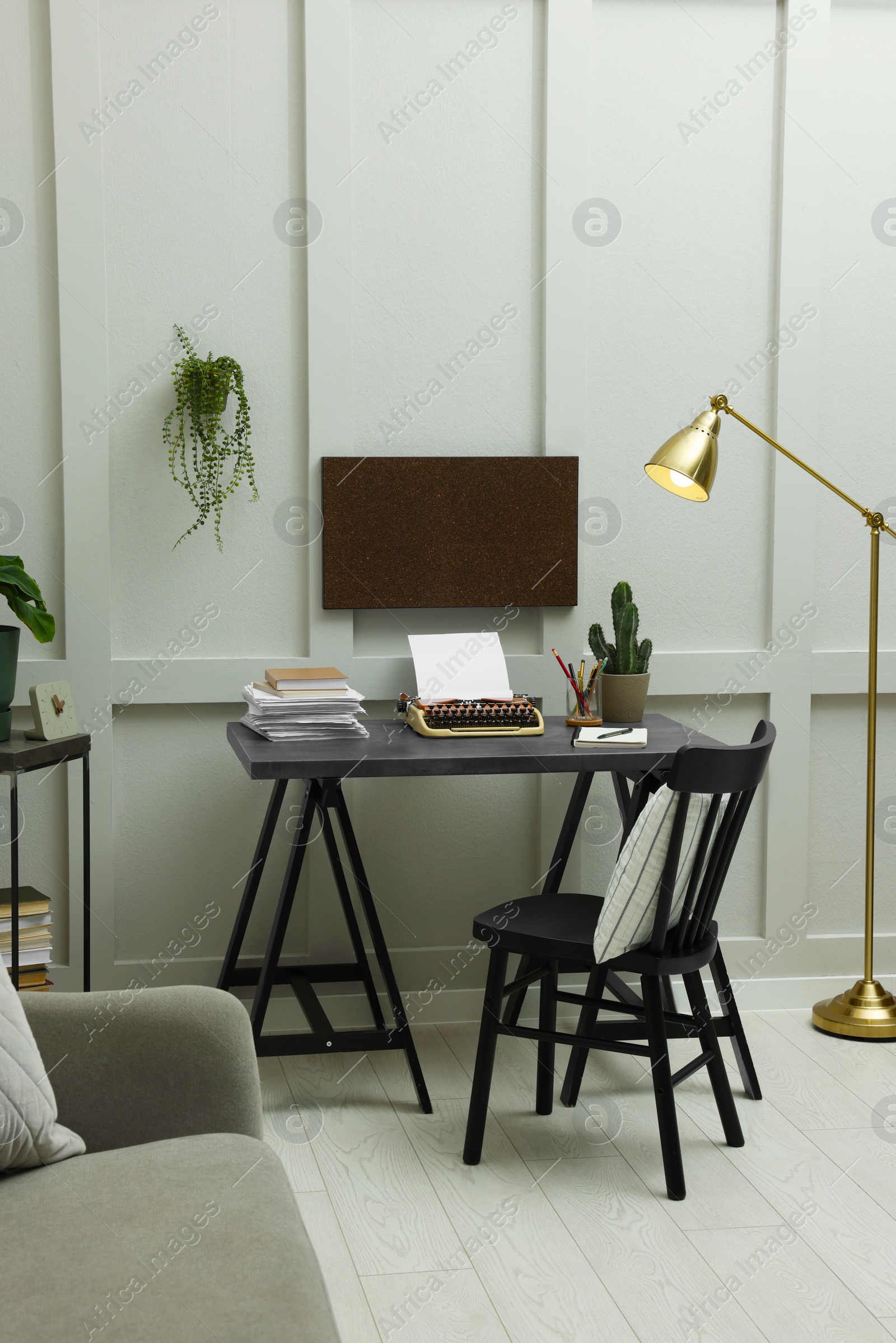 Photo of Writer's workplace with typewriter on dark table desk in room