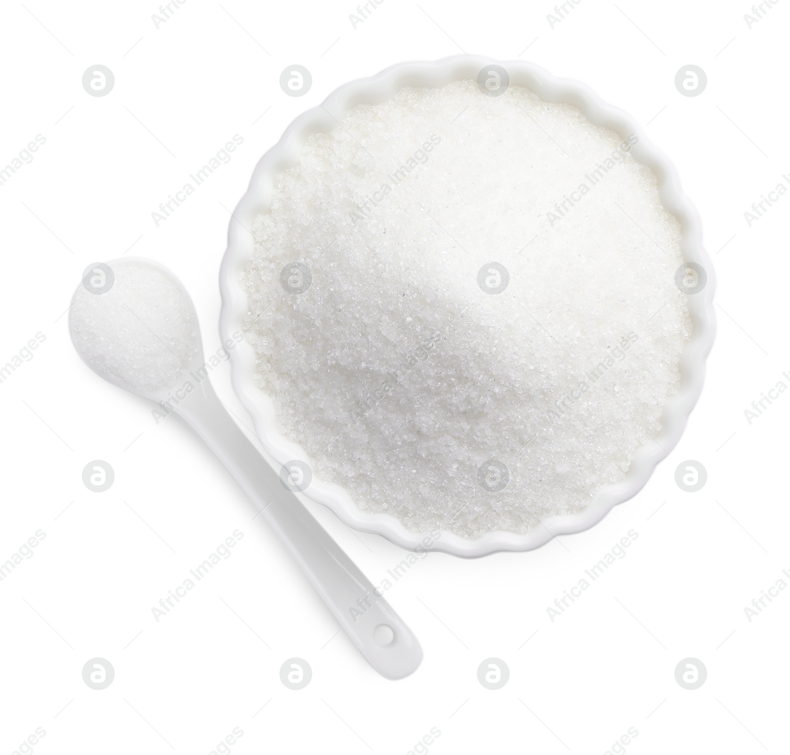 Photo of Granulated sugar in bowl and spoon isolated on white, top view