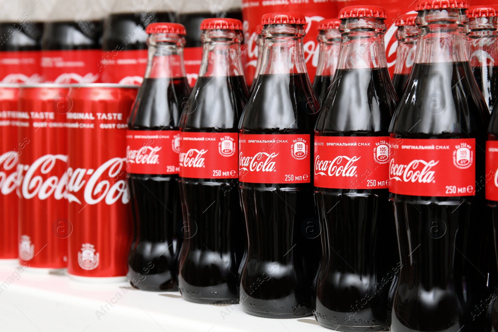 Photo of MYKOLAIV, UKRAINE - NOVEMBER 14, 2018: Coca-Cola cans and bottles on display in store