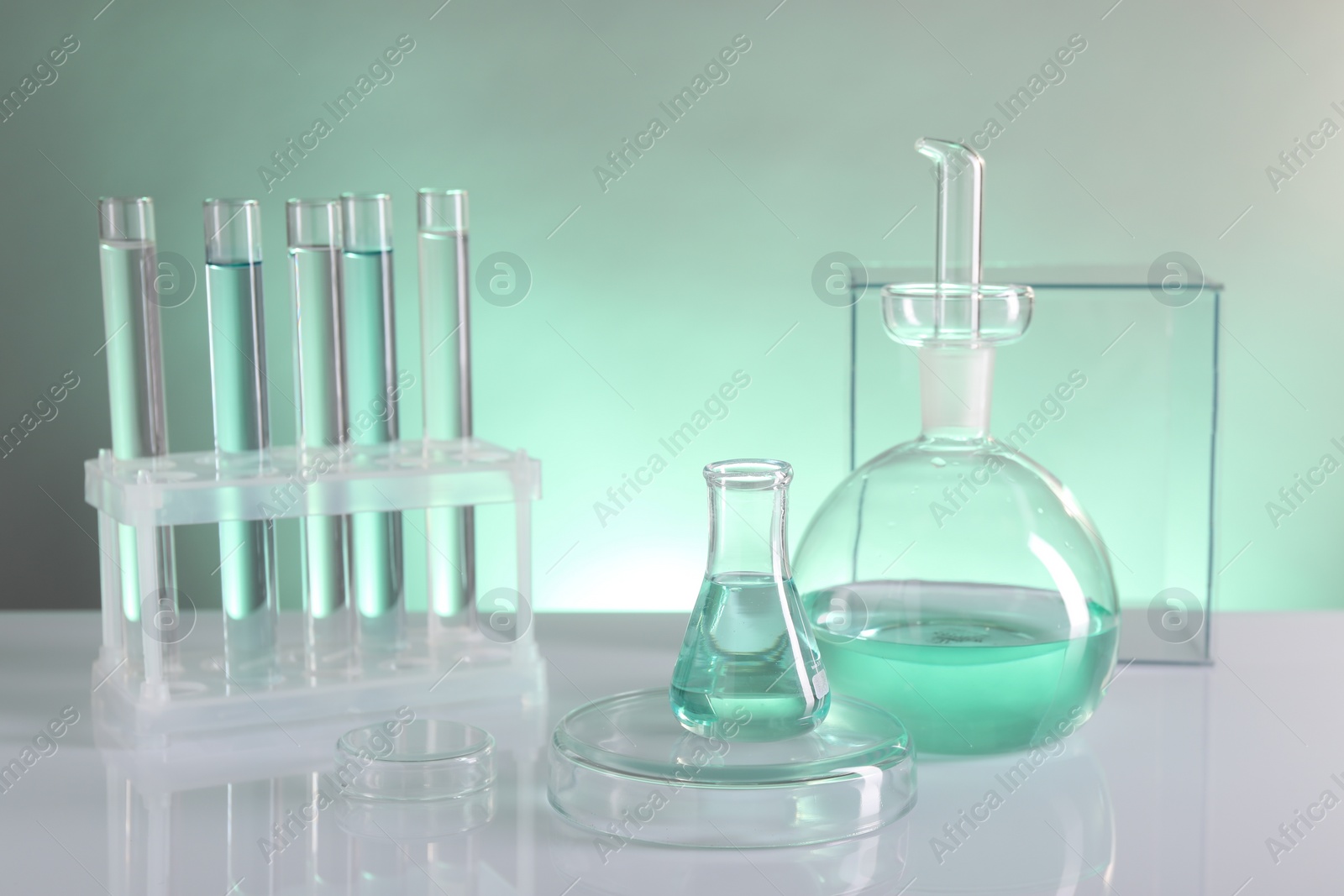 Photo of Laboratory analysis. Different glassware on table against color background