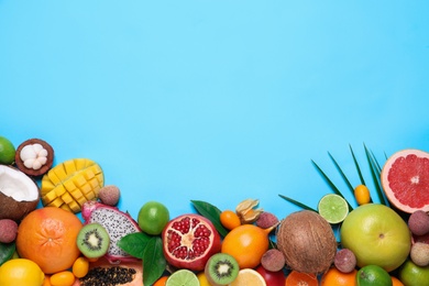 Photo of Different exotic fruits on light blue background, flat lay. Space for text