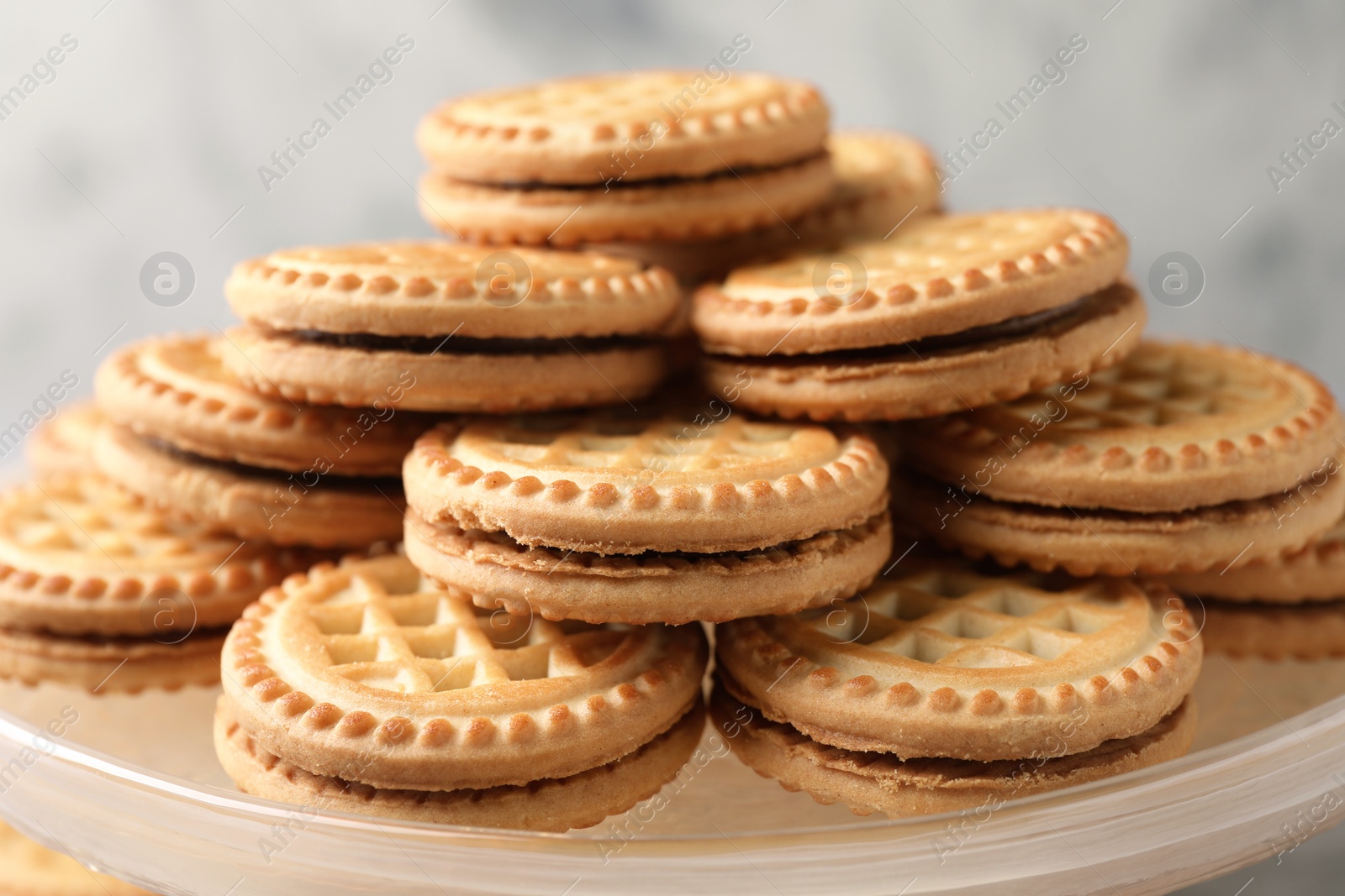 Photo of Tasty sandwich cookies with cream on tray, closeup
