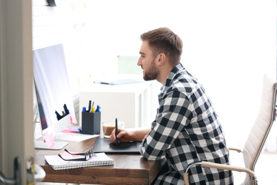 Photo of Male designer working at desk in office