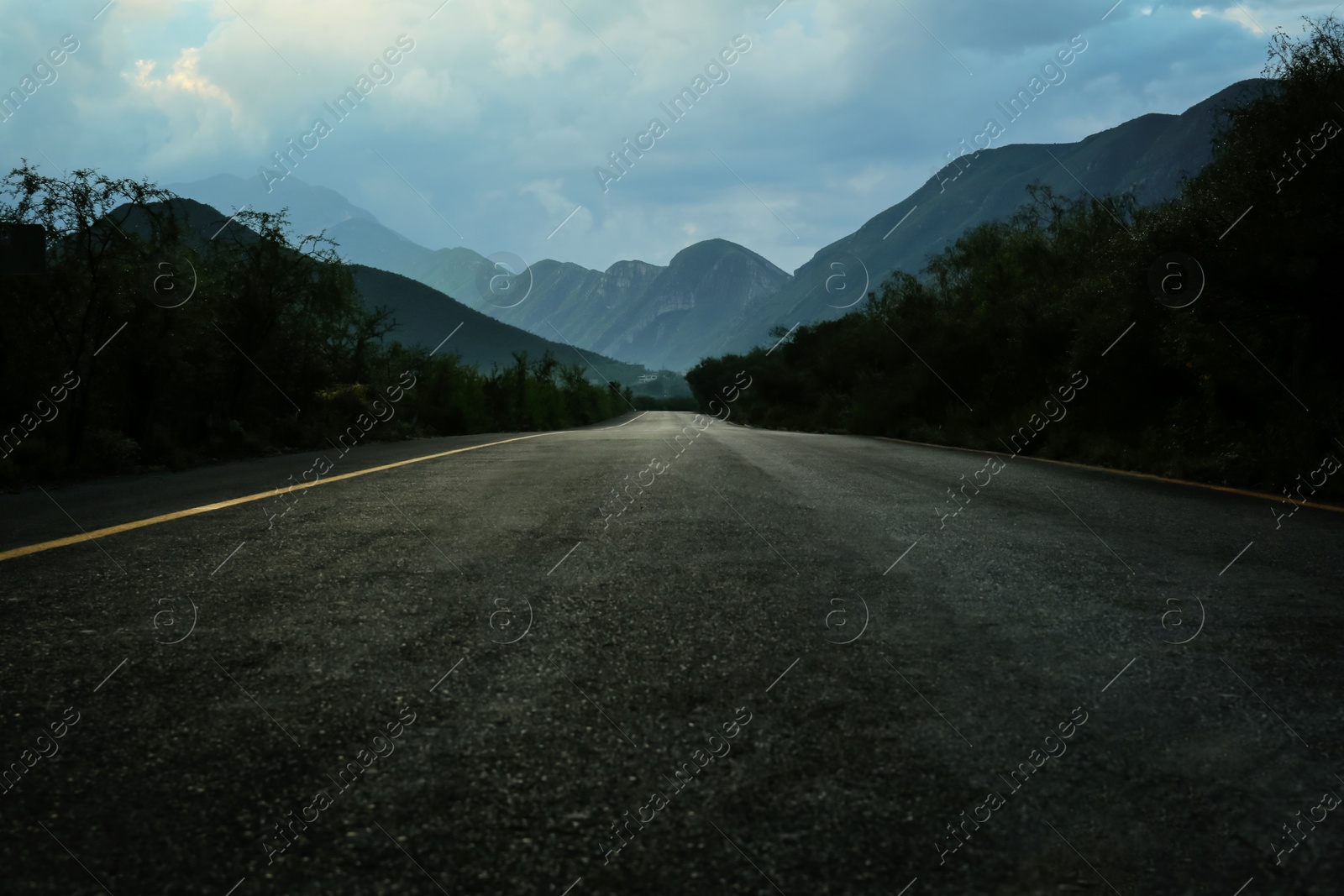 Photo of Beautiful view of empty asphalt highway near mountains outdoors. Road trip