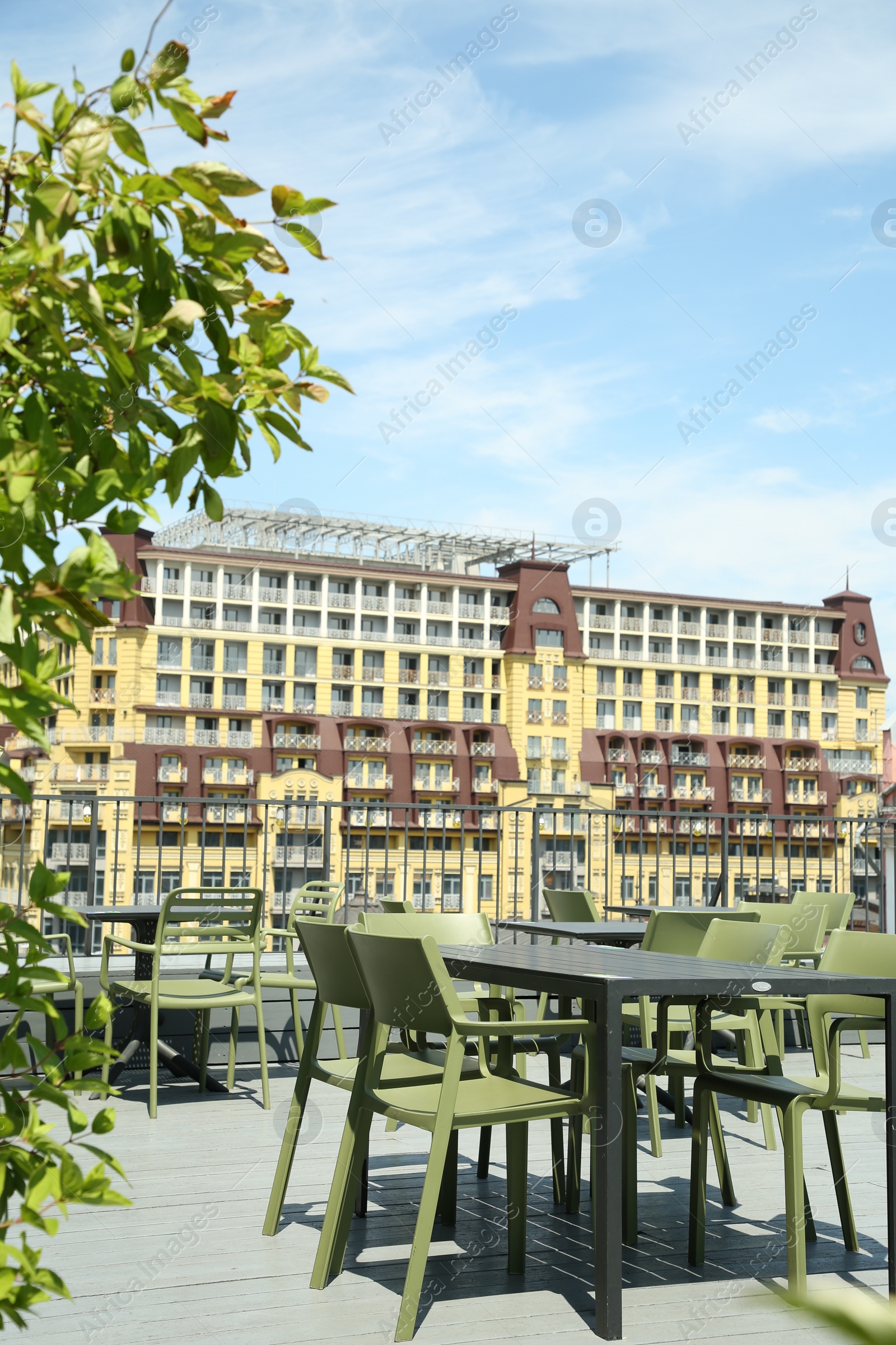 Photo of Observation area cafe. Tables and chairs on terrace against beautiful cityscape