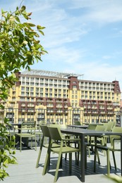 Photo of Observation area cafe. Tables and chairs on terrace against beautiful cityscape