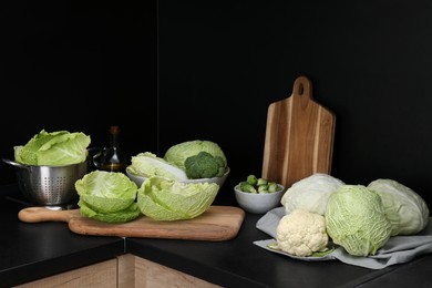 Photo of Different types of cabbage on countertop in kitchen