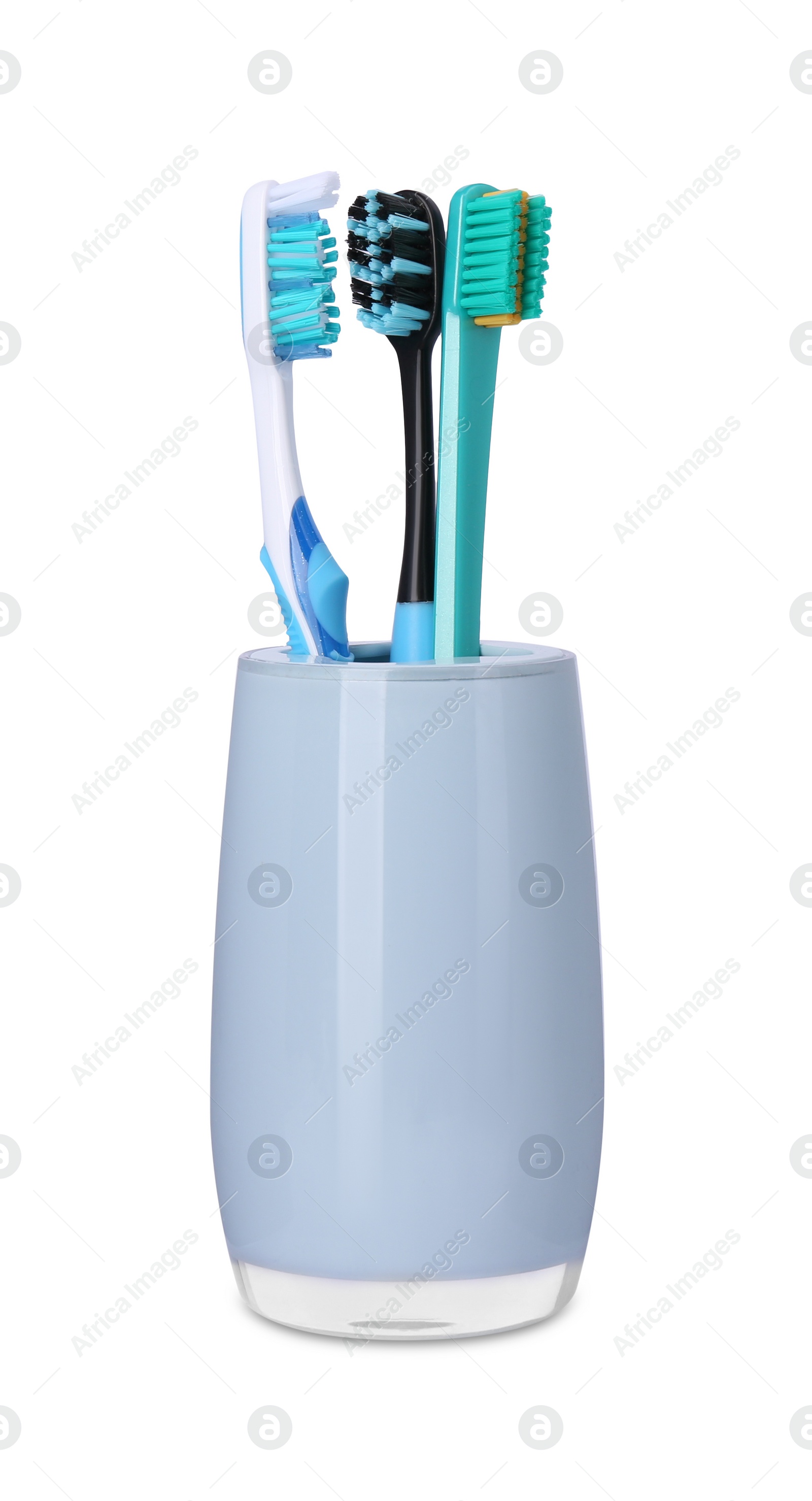 Photo of Different toothbrushes in holder isolated on white