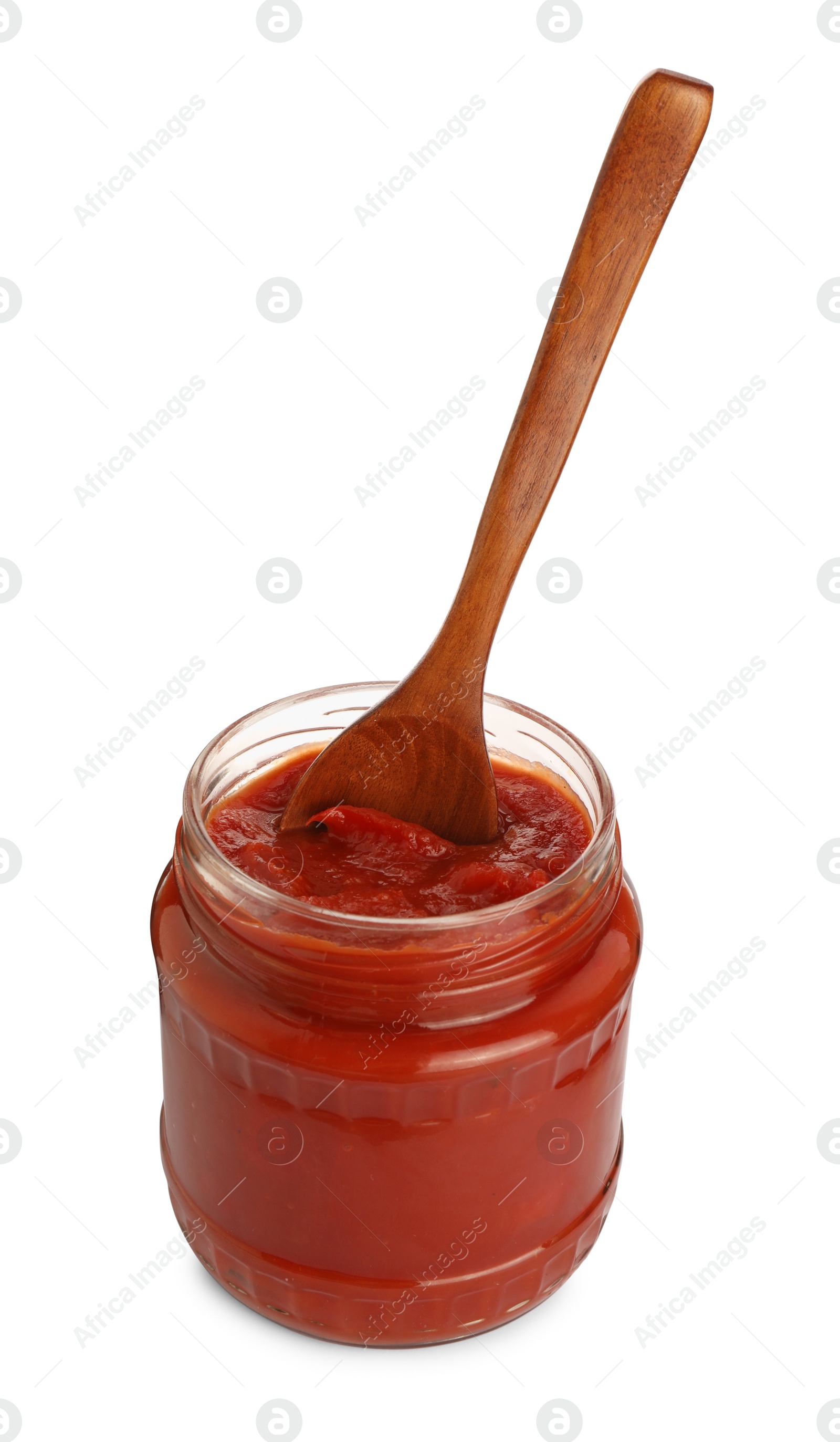 Photo of Glass jar of delicious canned lecho with wooden spoon isolated on white