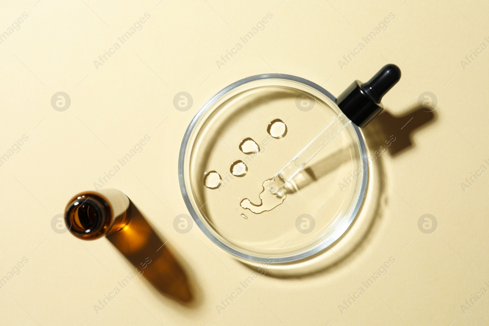 Photo of Petri dish and cosmetic product on beige background, flat lay