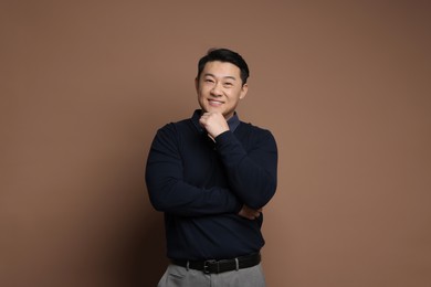 Portrait of happy man on brown background